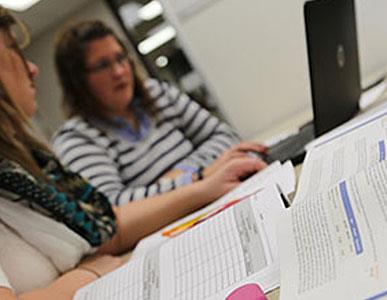 two people working on labtop computer