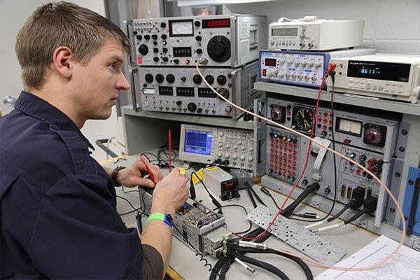 man working on aircraft electronics