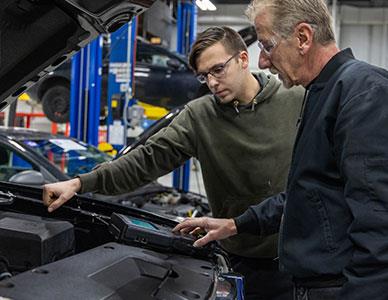 instructor demonstrating auto technology to student