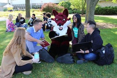 students sitting on FVTC campus in the yard