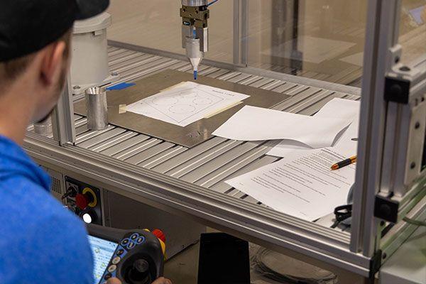 person working with automated machine with papers inside