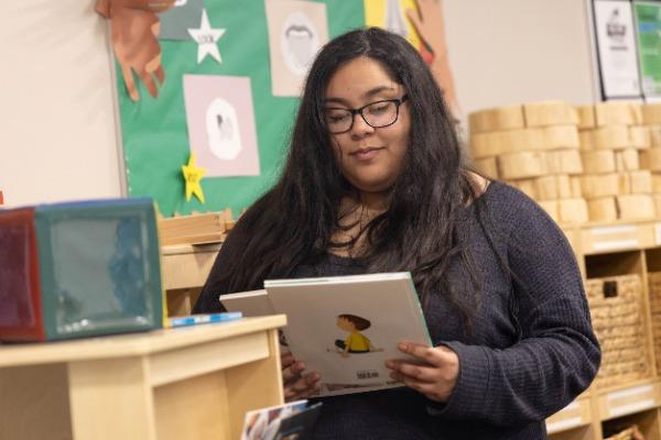 early childhood teacher picking out books