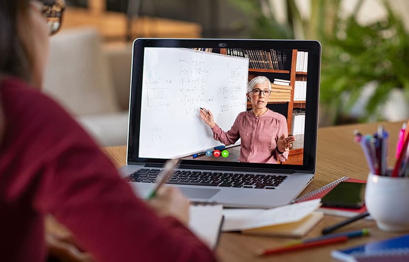 student taking virtual class on laptop