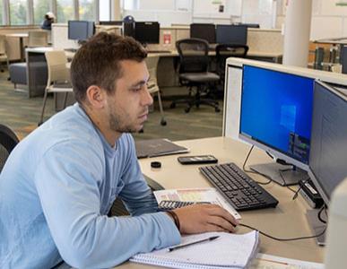 student in computer lab working on assignment