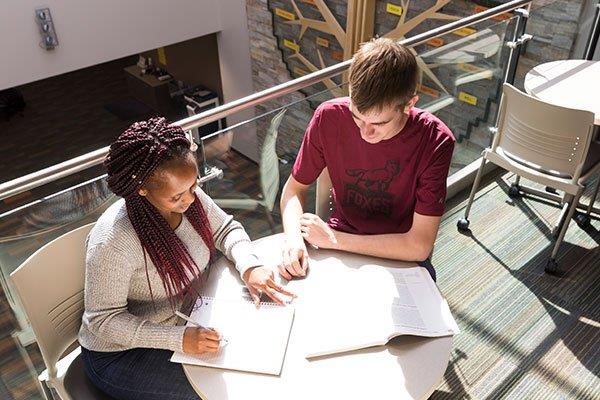 two people studying at table in Student Success Center at Fox Valley Tech