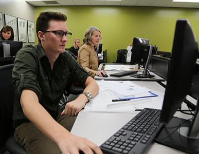 student and teacher working on computers