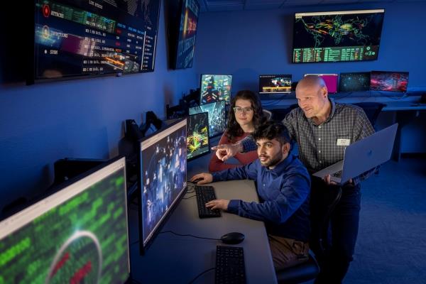 students and instructor working in cybersecurity lab