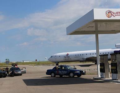 Fox Valley Tech public safety training center gas station with police cars and airplane in background