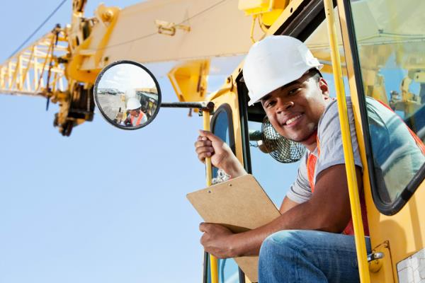 employee working as an operating engineer sitting in a crane