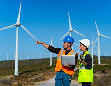 people in safety vests at wind farm