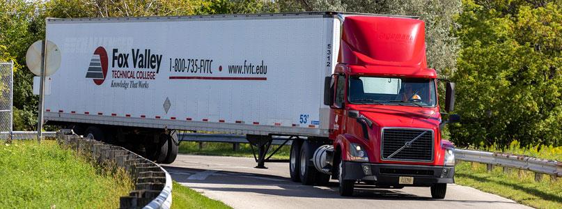 Fox Valley Tech semi truck and trailer turning a corner